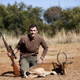 A hunter with an Impala that he shot at the Iwamanzi Game Reserve in South Africa’s North West Province.